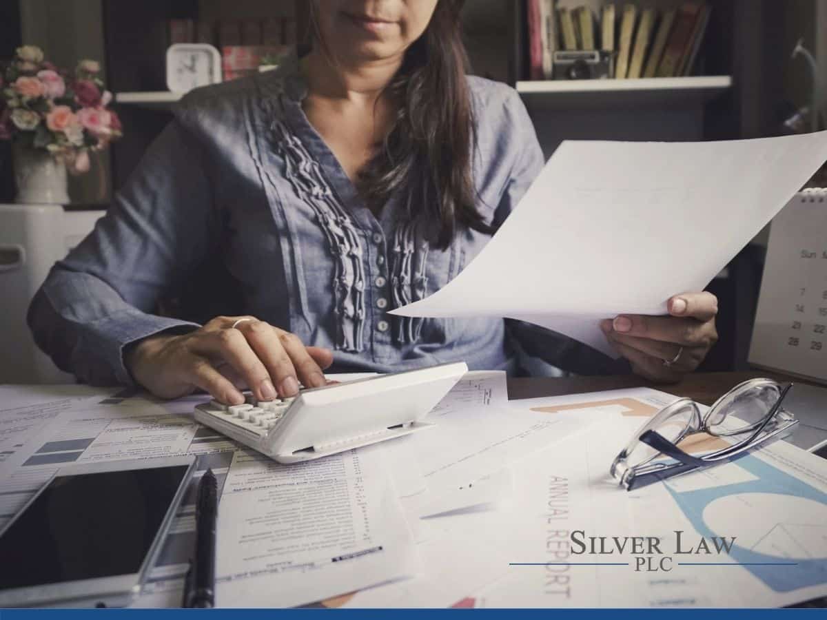 woman calculating his annual tax on from your office  desk.