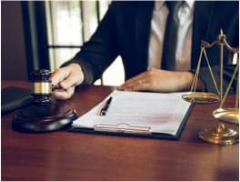 Lawyer holding a gavel and tax documents