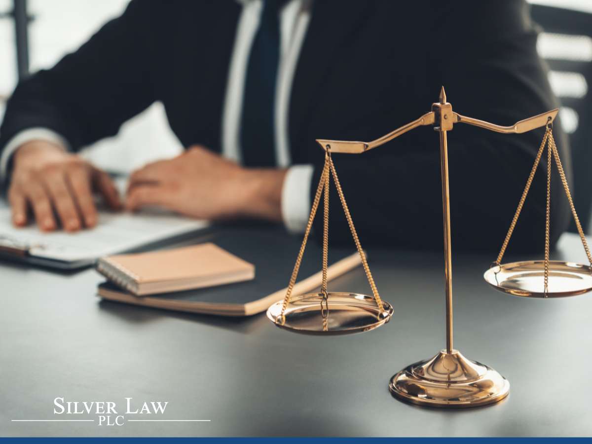 Golden scales on a desk with a lawyer in the background, representing due diligence for the Corporate Transparency Act